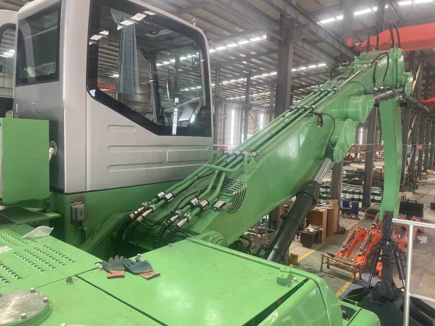 50-ton hydraulic material handler with grab attachment on the assembly floor in Rushan, Shandong