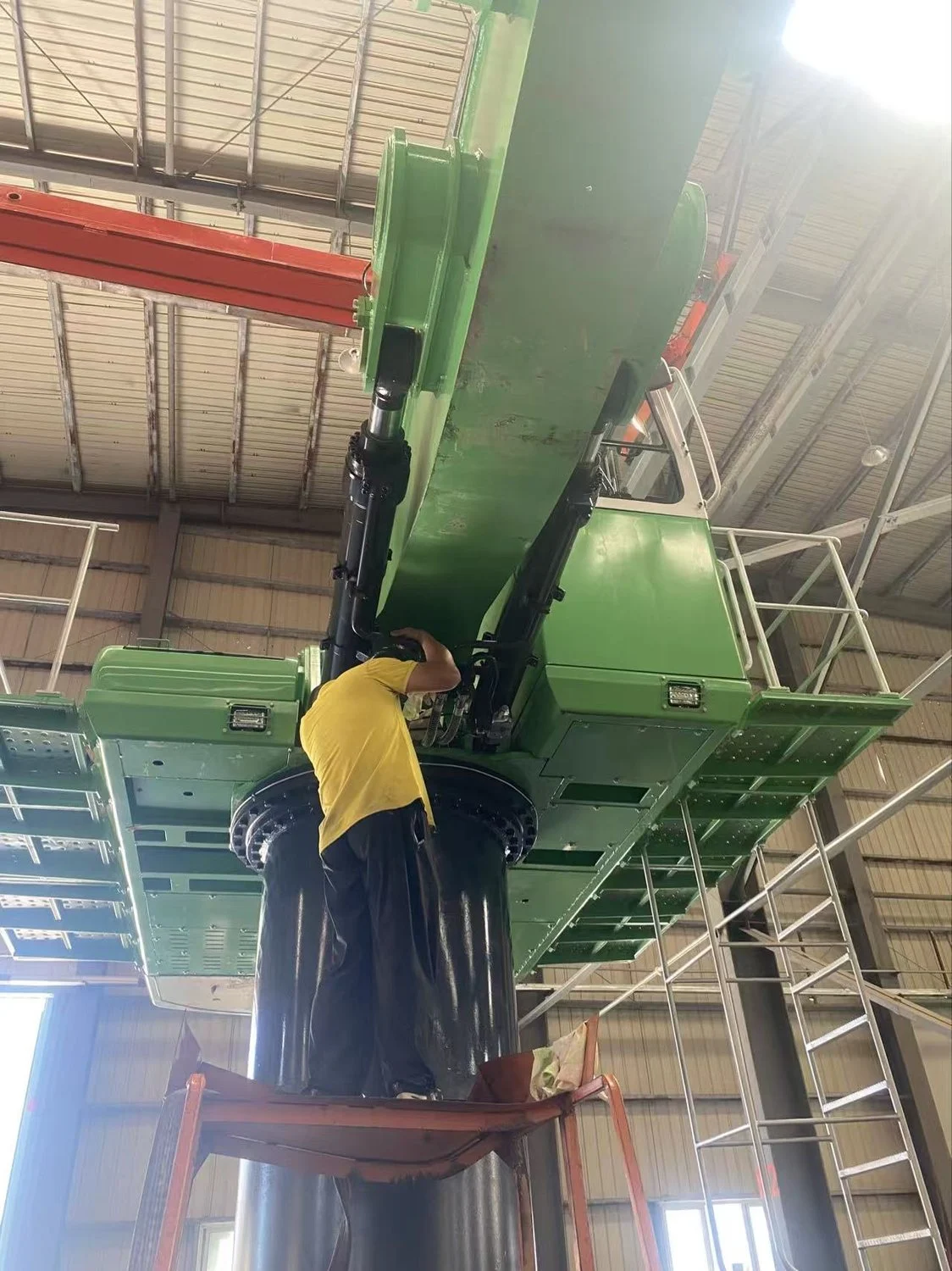 SeeZol engineer fitting an LMI sensor at the boom root platform of a 50-ton material handler